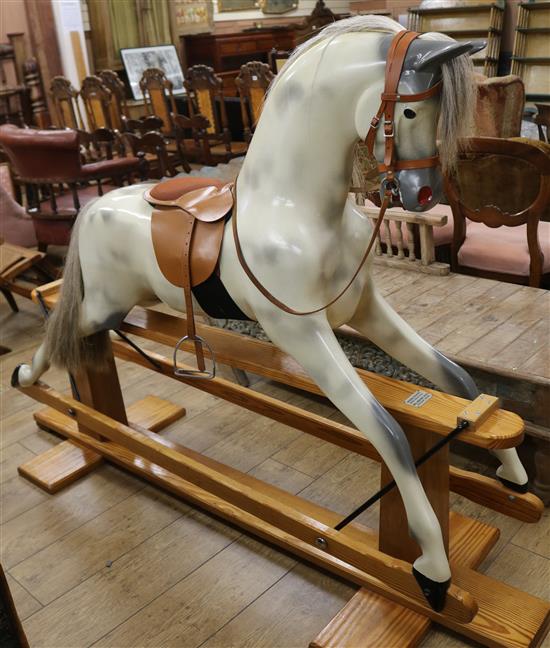 A Haddon Rockers dapple grey rocking horse, on pine trestle, L.approx. 6ft